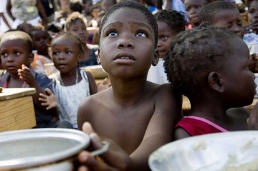 A child awaits for the distribution of meals by WFP (United Nations World Food Program)