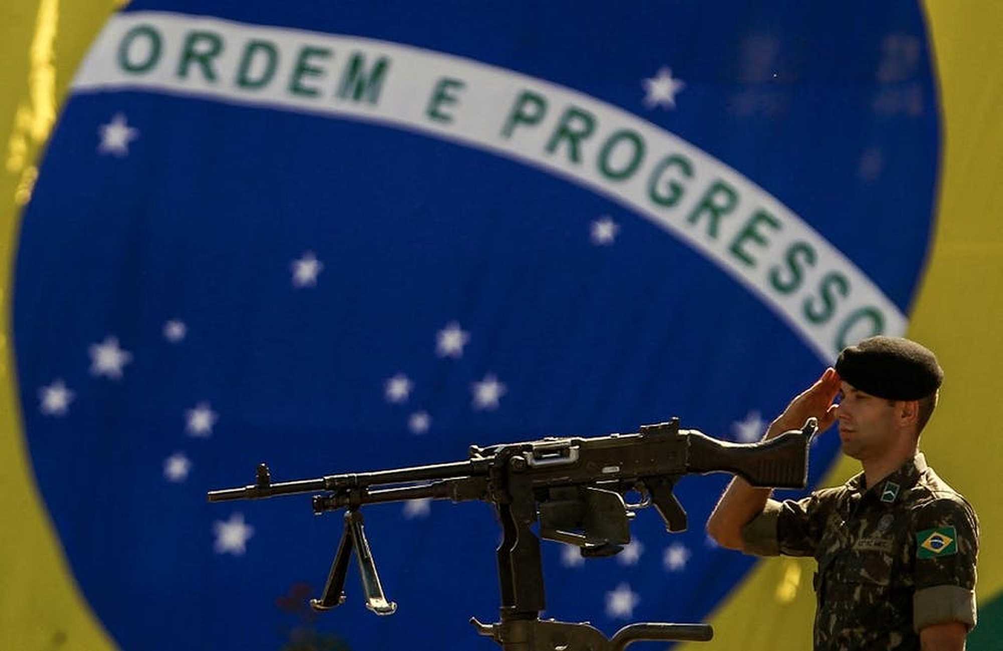 A soldier stands guard in front of the Brazilian national flag on Army Day in São Paulo. Miguel Schincariol/AFP