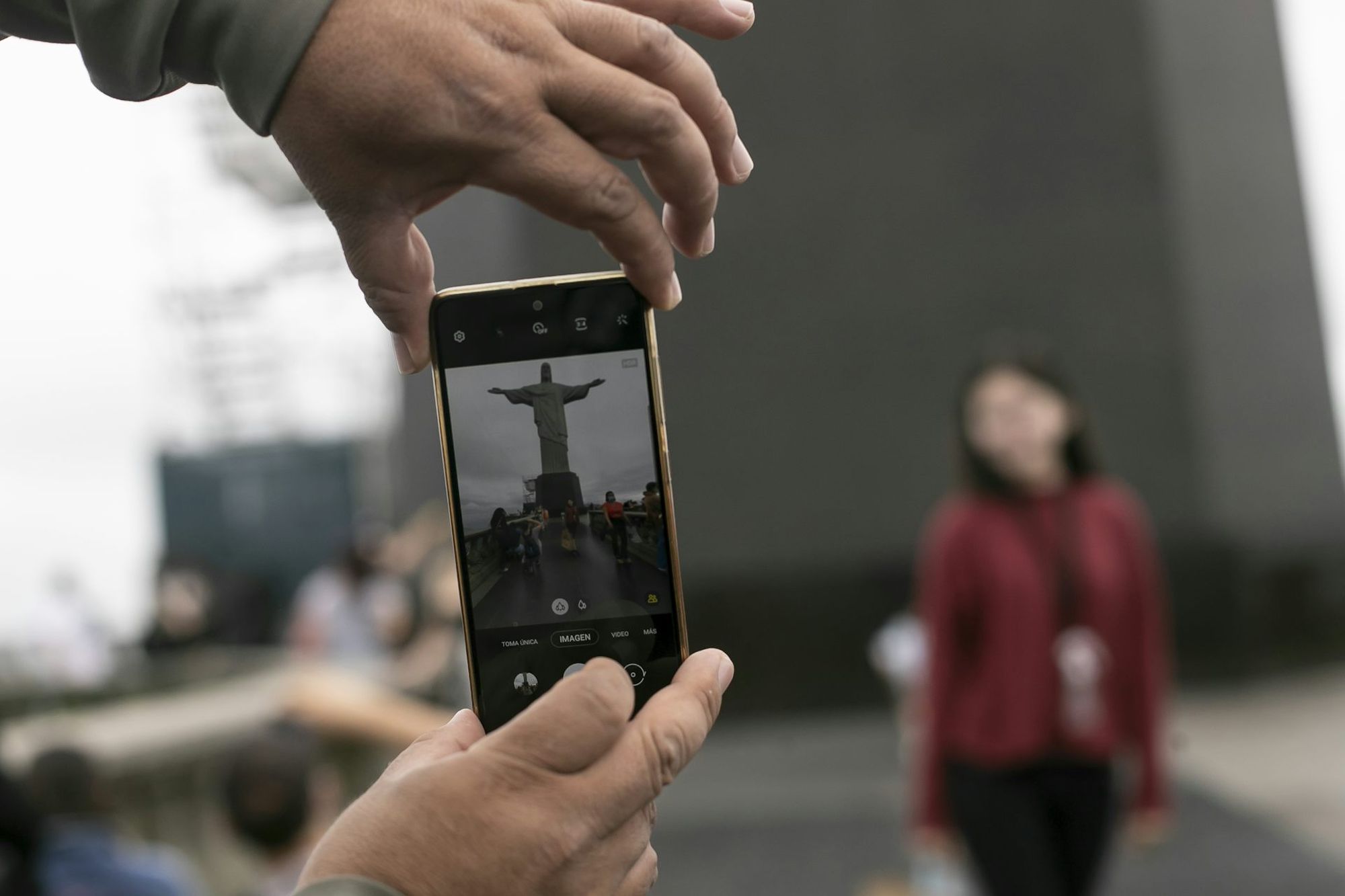 A tourist captures a moment in front of the Christ the Redeemer statue in Rio.